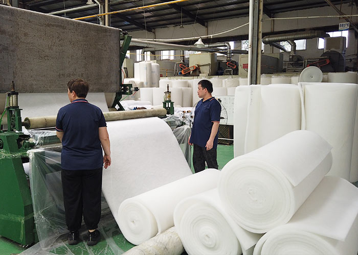 Workers producing G2 G3 G4 air intake pre filter media rolls in factory