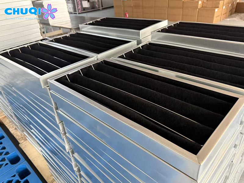 Custom activated carbon air filter factory with metal frame panel units stacked for wholesale HVAC gas adsorption.